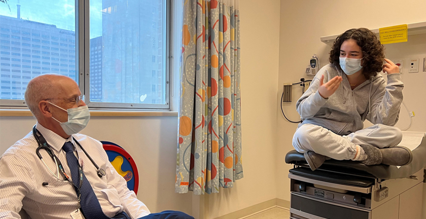 Dr. David Malkin sits in a hospital room with Juliet Locke.