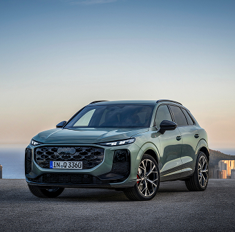 A luxury SUV parked against a dusky sky
