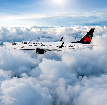 An Air Canada plane flying against a backdrop of fluffy clouds